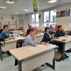 Viele aufmerksame Menschen der älteren Generation sitzen in einem Unterrichtsraum in der Gesamtschule Niederaula. Sie hören gespannt zu, was Ihnen erklärt wird. Auch Dirk Noll ist in dem Raum.