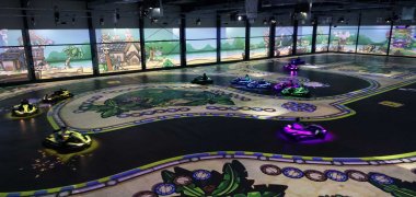 Indoor Kartbahn mit bunten Lichtern.